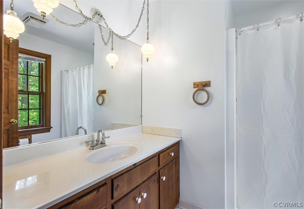 22601 Skinquarter Road Moseley, VA 23120 - Photo 26 of 50 a bathroom with a sink vanity granite and a mirror