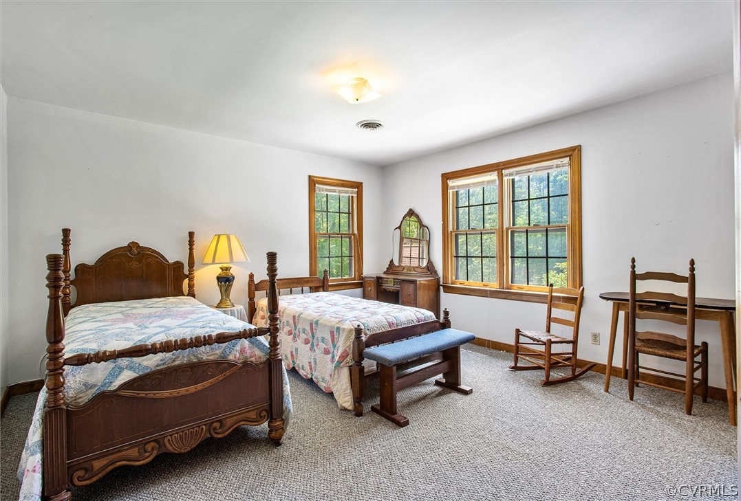22601 Skinquarter Road Moseley, VA 23120 - Photo 30 of 50 a bedroom with a bed and a chandelier