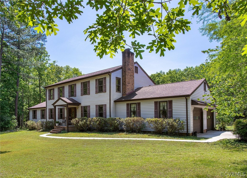 22601 Skinquarter Road Moseley, VA 23120 - Photo 3 of 50 a front view of a house with a garden and trees