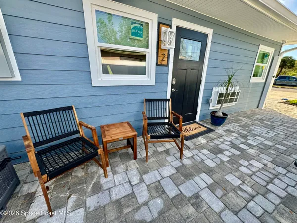 a view of a chairs with wooden floor and bench in kitchen