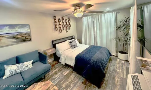 a bed sitting in a bedroom next to a window
