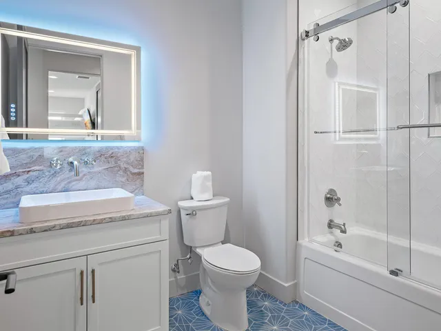 a bathroom with a sink toilet and shower
