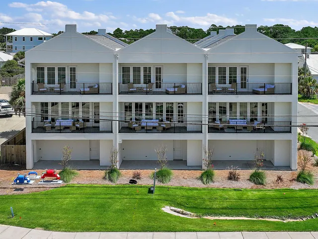 an aerial view of residential houses with outdoor space and street view