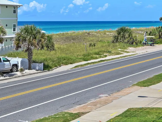 a view of a floor to ceiling window and an ocean view
