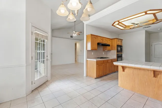 a view of a dining room with furniture and chandelier