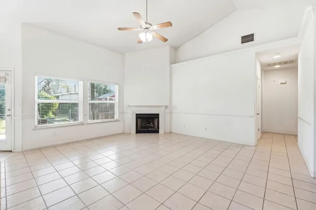 a living room with furniture a flat screen tv and a large window