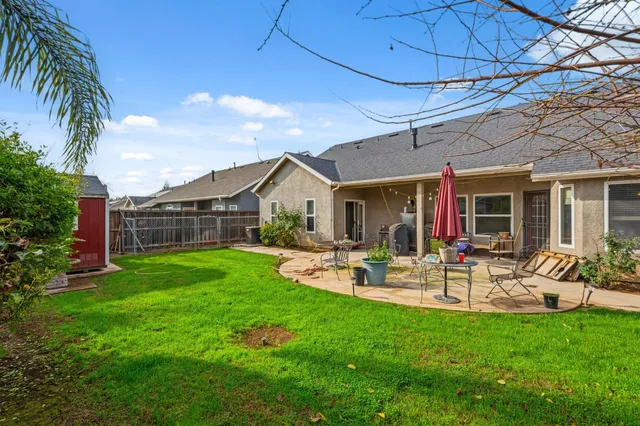 a front view of a house with yard patio and green space