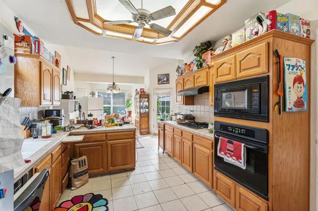 a kitchen with a sink a counter top space cabinets and stainless steel appliances