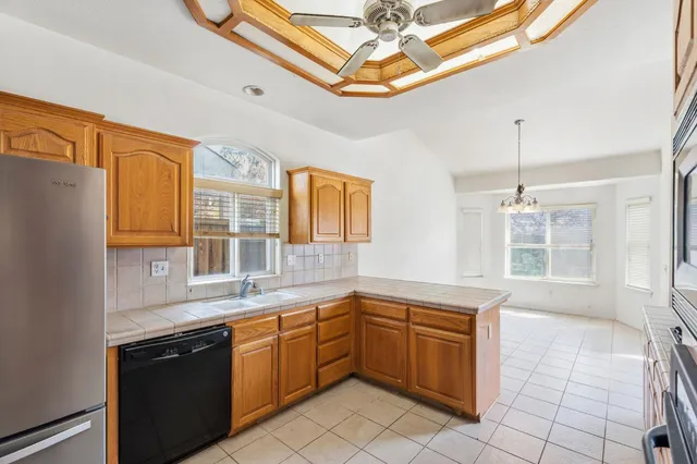a kitchen filled a sink and stove