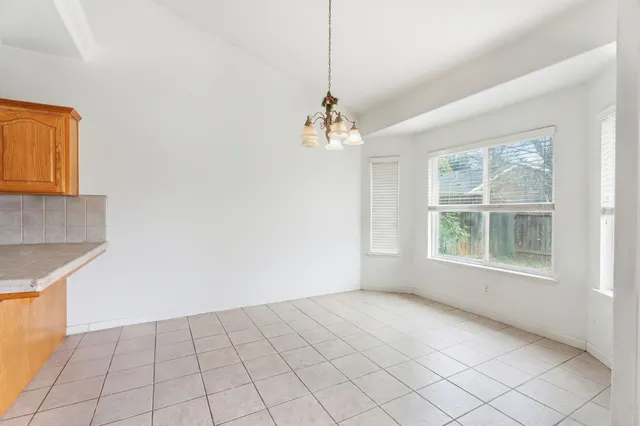 a living room with furniture a flat screen tv and a table