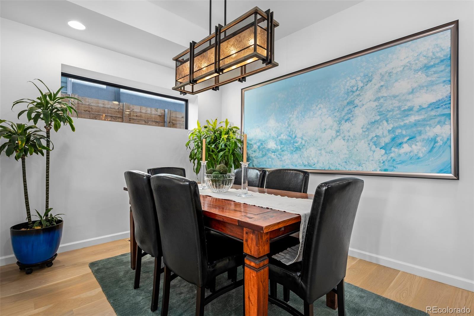 3451 Quivas Street Denver, CO 80211 - Photo 16 of 50 a view of a dining room with furniture and potted plant