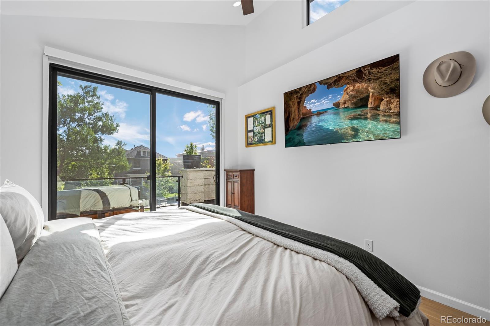 3451 Quivas Street Denver, CO 80211 - Photo 21 of 50 a bedroom with a bed painting on wall and a large window