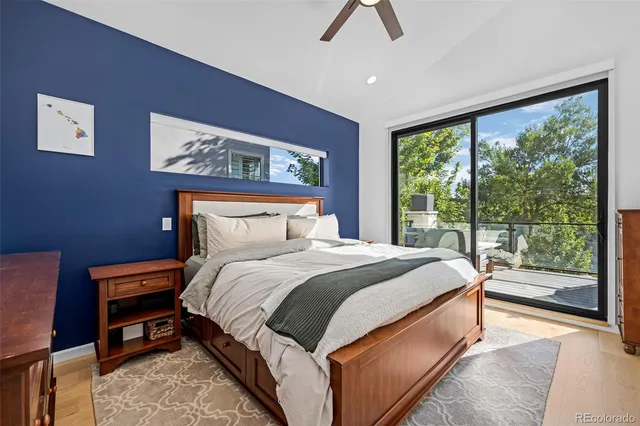 a bedroom with bed and painting on the wall