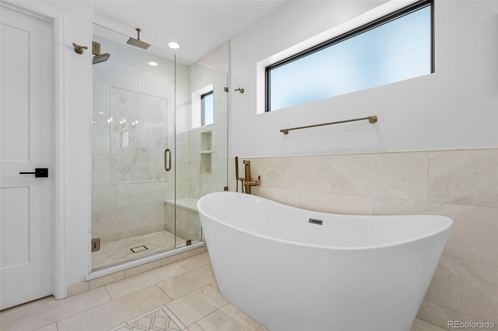 3451 Quivas Street Denver, CO 80211 - Photo 25 of 50 a white bath tub sitting next to a shower