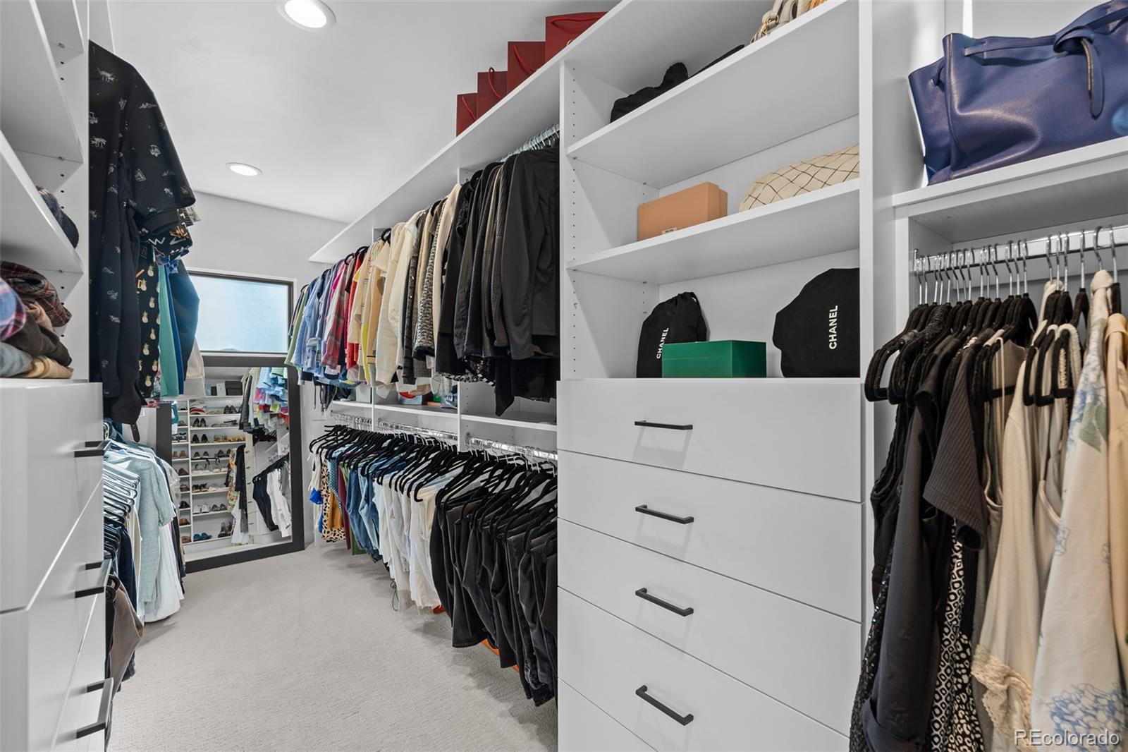 3451 Quivas Street Denver, CO 80211 - Photo 26 of 50 a view of walk in closet with clothes and shoes