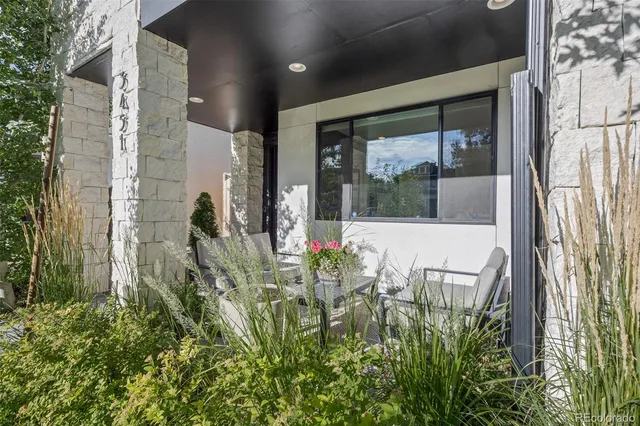 a kitchen with stainless steel appliances a kitchen island hardwood floor sink stove dining table and chairs