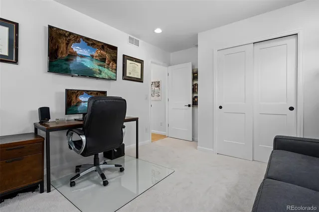 a room with table chairs and a potted plant