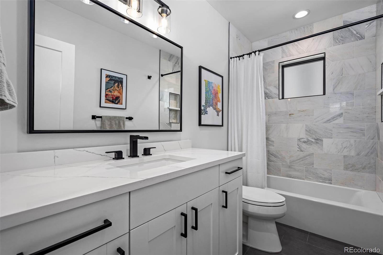 3451 Quivas Street Denver, CO 80211 - Photo 32 of 50 a bathroom with a sink a toilet and shower