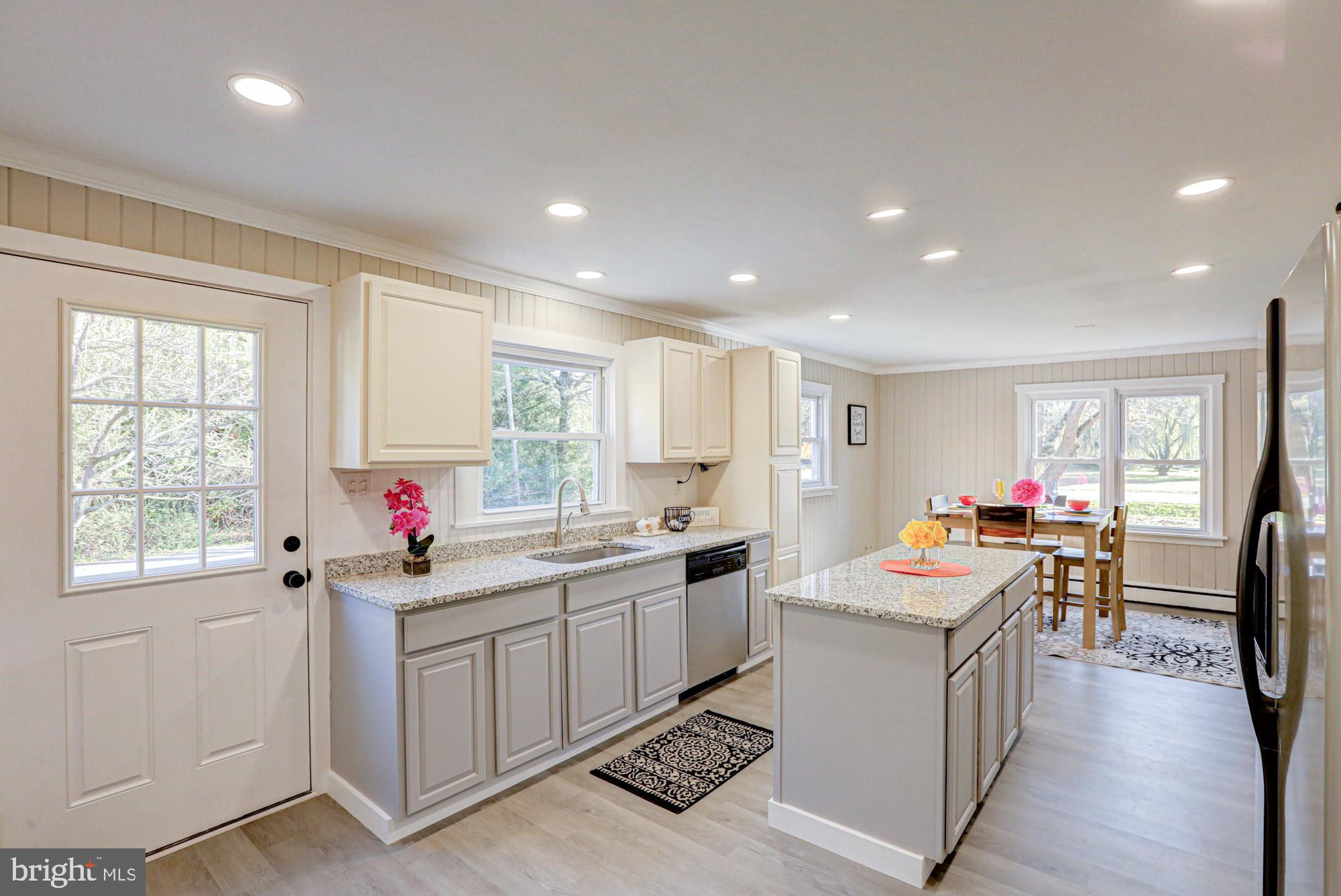 4841 Sandtown Road Felton, DE 19943 - Photo 24 of 70 a kitchen that has a lot of cabinets in it and wooden floors