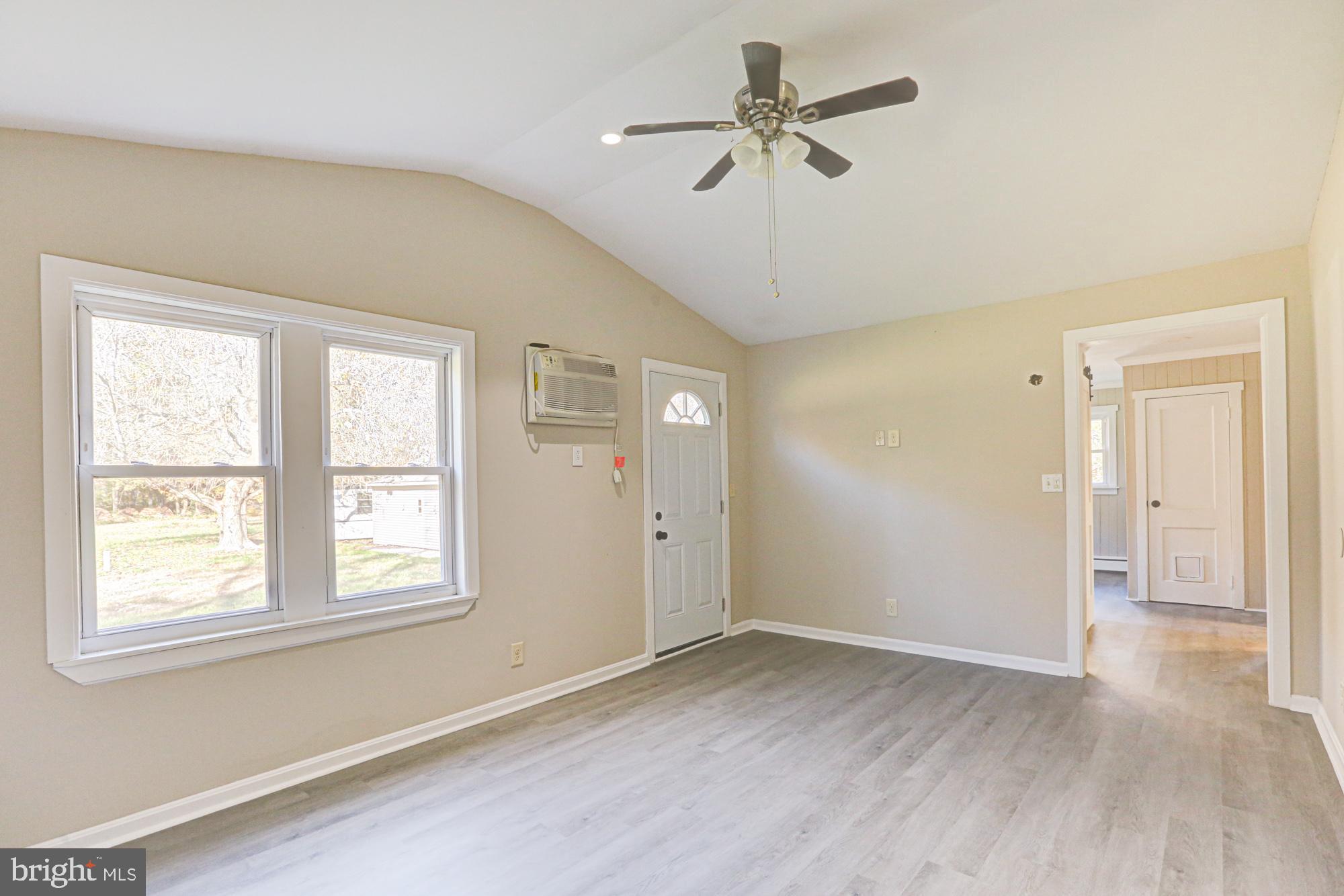 4841 Sandtown Road Felton, DE 19943 - Photo 27 of 70 a view of a big room with wooden floor and windows
