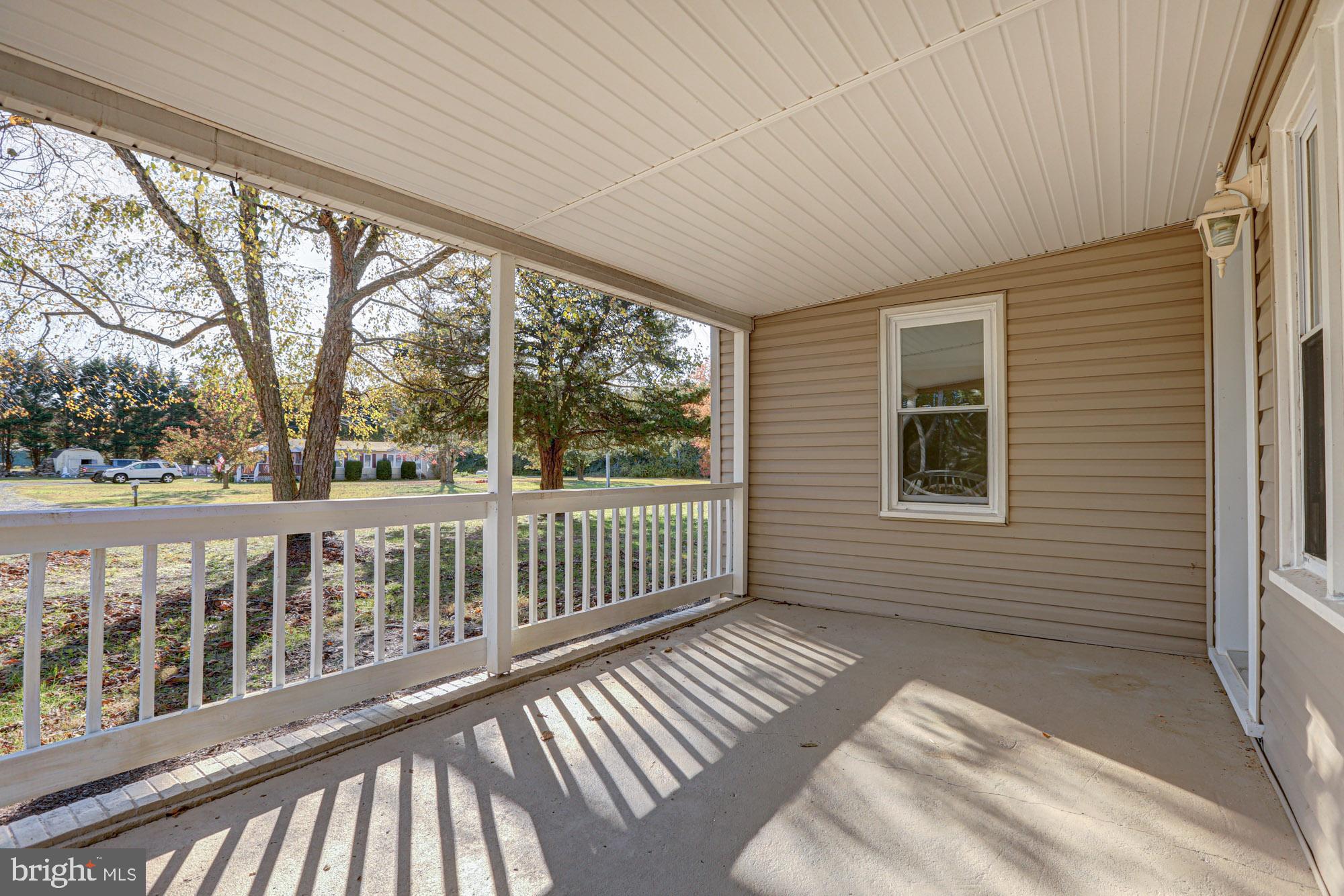 4841 Sandtown Road Felton, DE 19943 - Photo 3 of 70 Inviting covered porch bathed in sunlight.