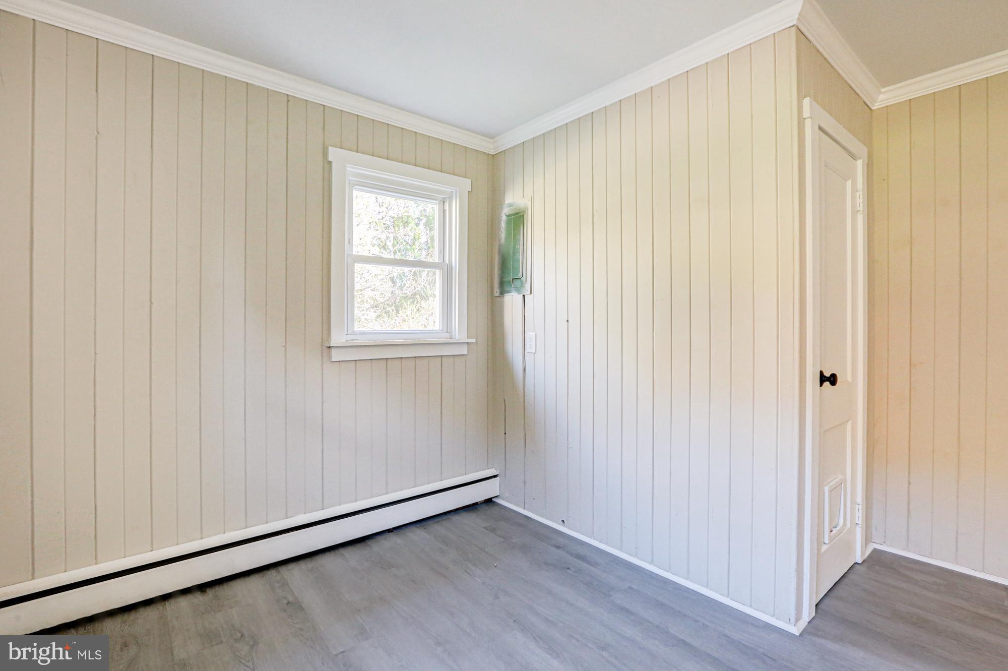 4841 Sandtown Road Felton, DE 19943 - Photo 37 of 70 a view of an empty room with wooden floor and a window