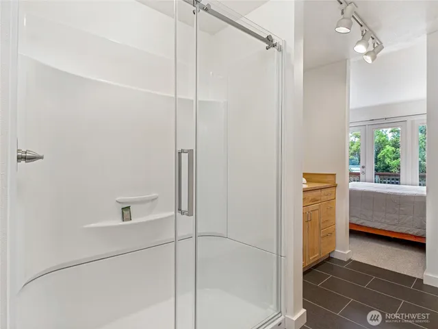 a view of a balcony with floor to ceiling windows with wooden floor