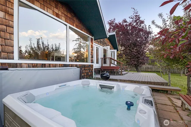 a view of a backyard with plants and a bench