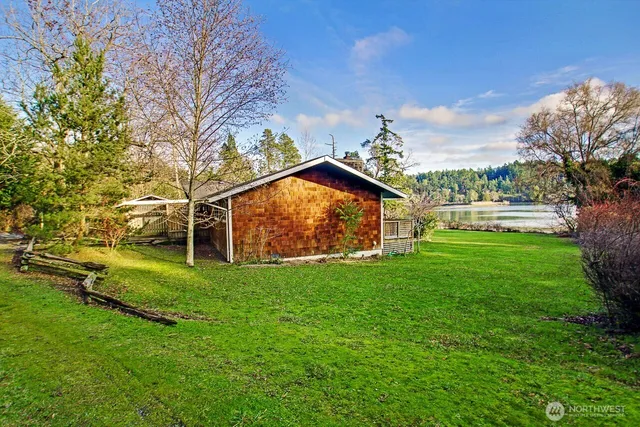 a view of a large house with a yard and large trees