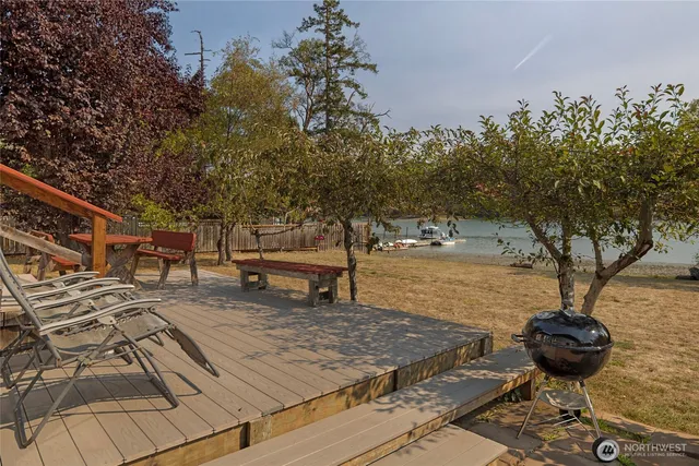 a view of a back yard with a lake view