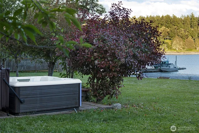 a view of a backyard with plants and a bench