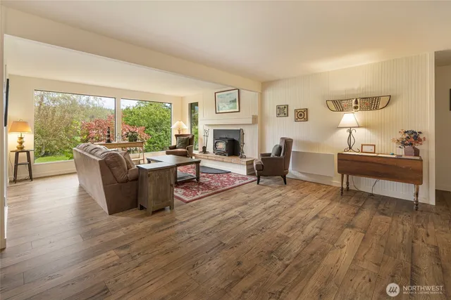 a living room with furniture a large window and a fireplace