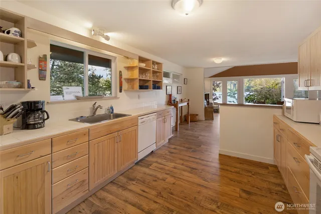 a kitchen with white cabinets and white appliances