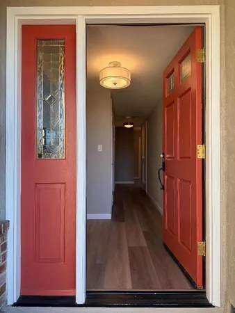a view of a hallway with wooden floor
