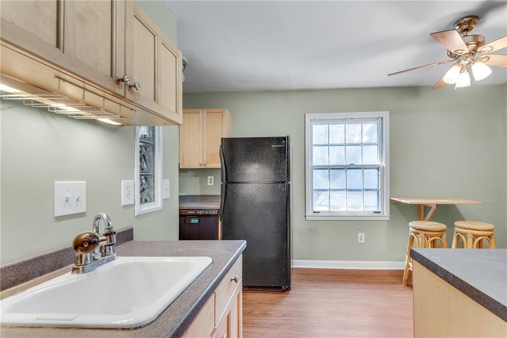 134 Lablanc Way Northwest Atlanta, GA 30327 - Photo 14 of 42 a kitchen with stainless steel appliances granite countertop a sink a refrigerator and a stove