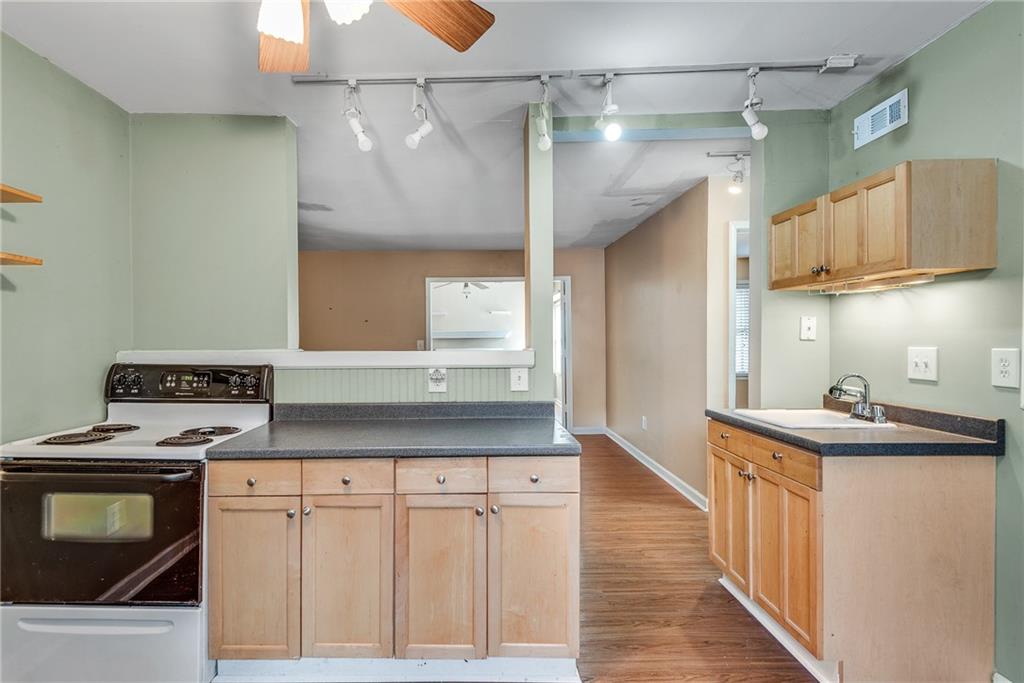 134 Lablanc Way Northwest Atlanta, GA 30327 - Photo 16 of 42 a kitchen with stainless steel appliances granite countertop a sink stove and refrigerator
