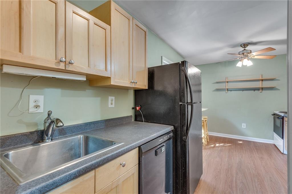 134 Lablanc Way Northwest Atlanta, GA 30327 - Photo 21 of 42 a kitchen with stainless steel appliances granite countertop a granite counter tops refrigerator a sink and dishwasher with wooden floor