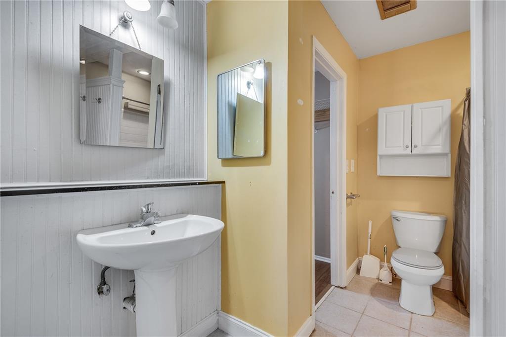 134 Lablanc Way Northwest Atlanta, GA 30327 - Photo 22 of 42 a bathroom with a toilet sink and mirror