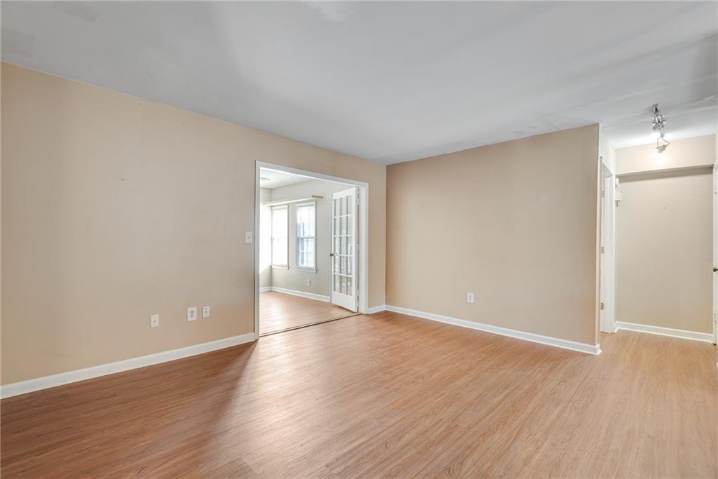 134 Lablanc Way Northwest Atlanta, GA 30327 - Photo 5 of 42 a view of an empty room with wooden floor and a window