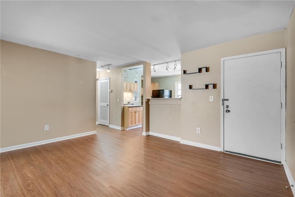 134 Lablanc Way Northwest Atlanta, GA 30327 - Photo 8 of 42 a view of a kitchen with wooden floor and a refrigerator