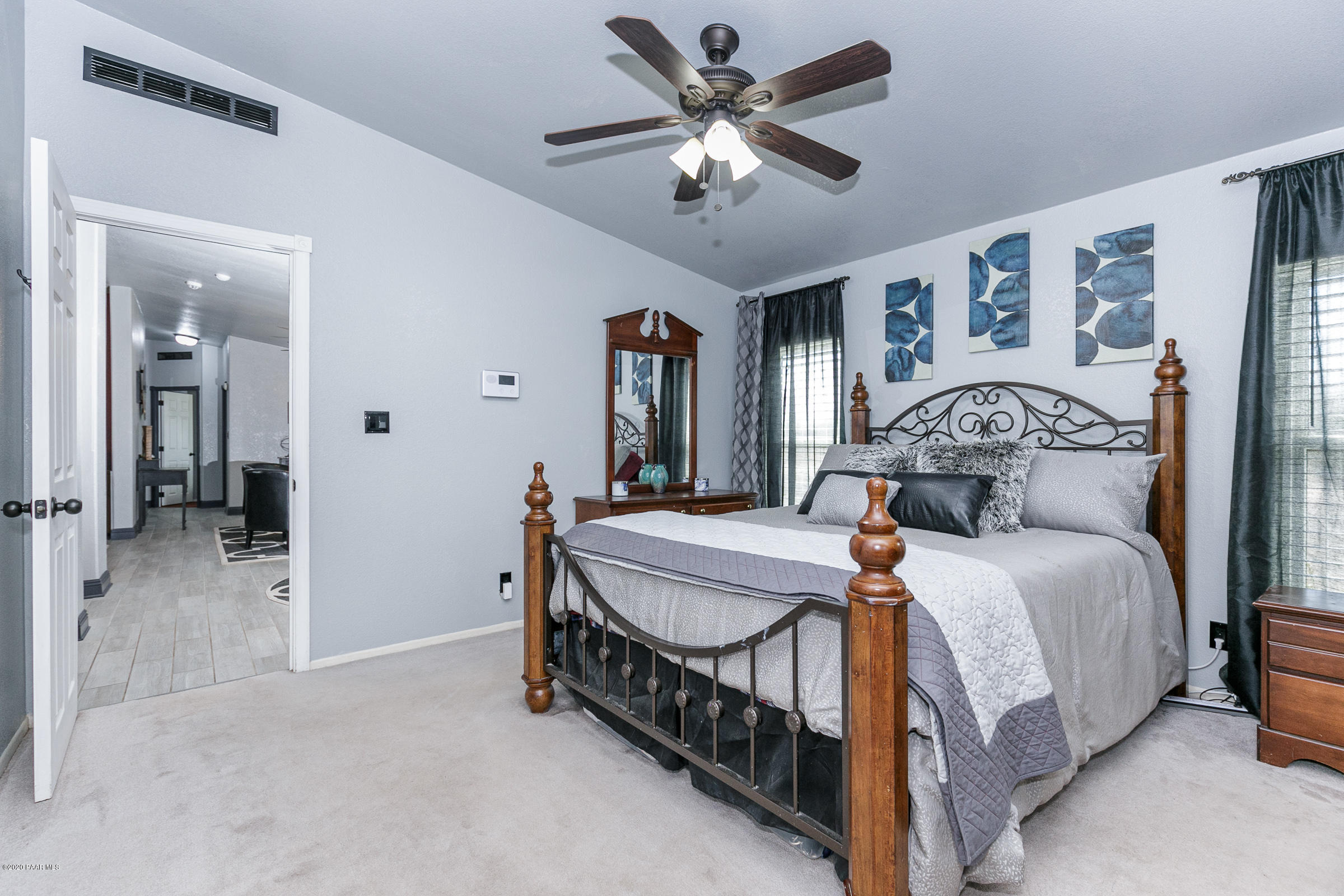22355 North Docs Road Paulden, AZ 86334 - Photo 11 of 39 a bedroom with a bed and a chandelier