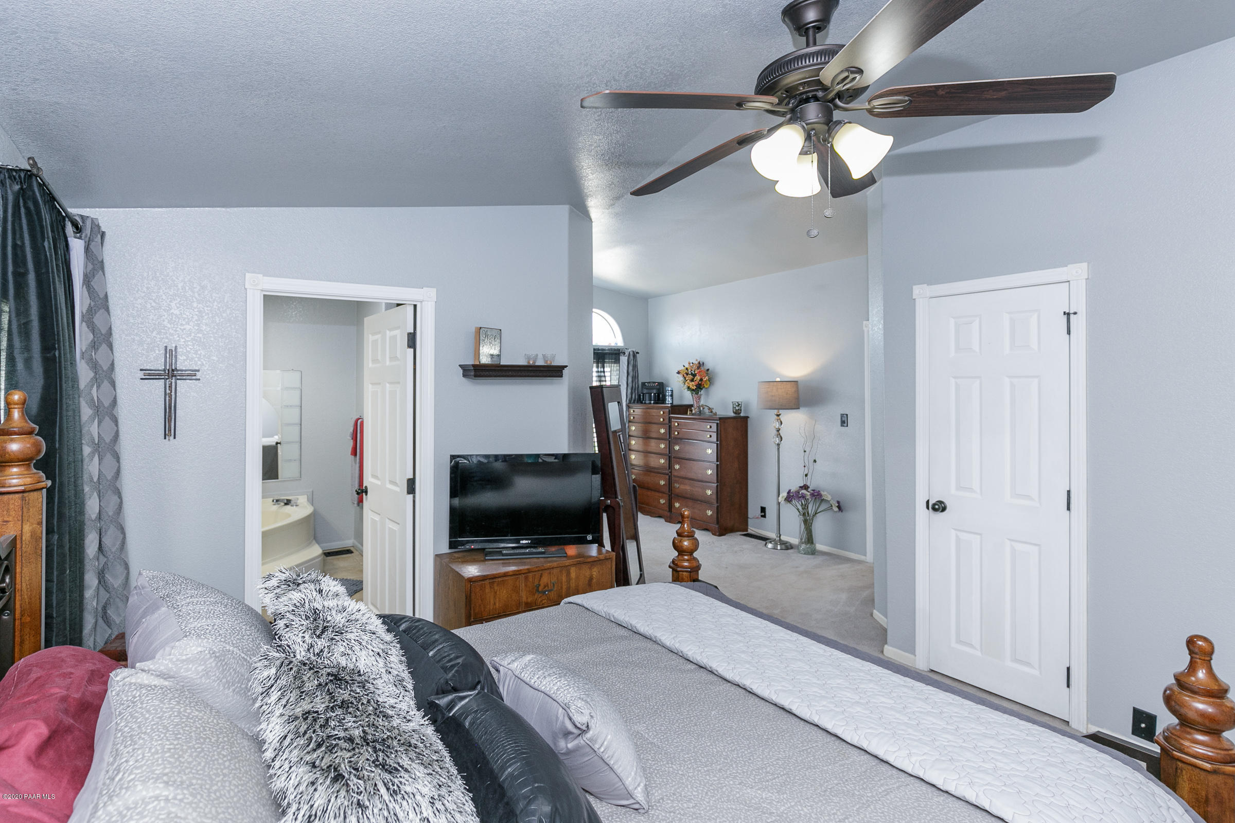 22355 North Docs Road Paulden, AZ 86334 - Photo 12 of 39 a bedroom with a large bed a flat tv screen and a walk in closet