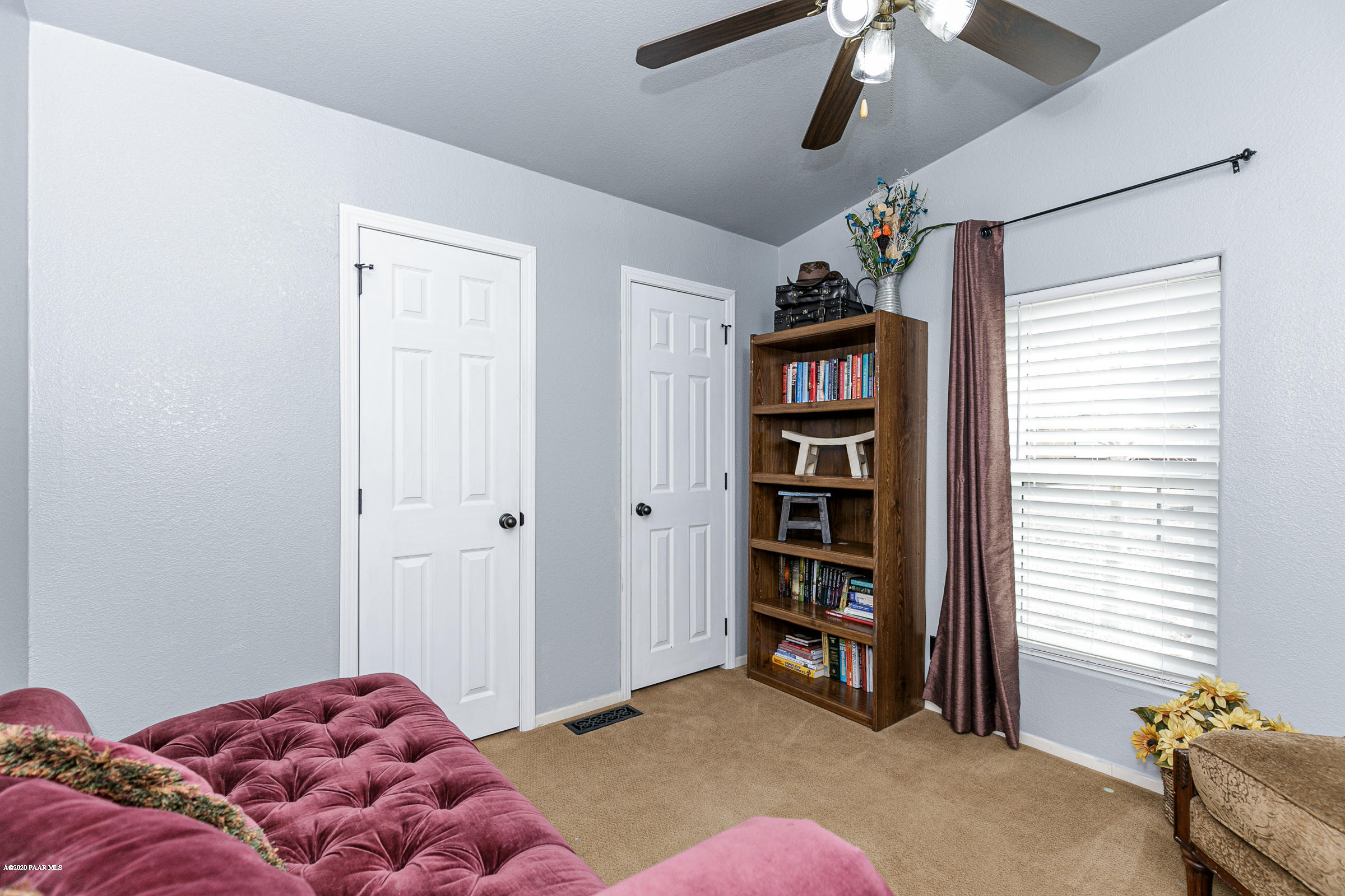 22355 North Docs Road Paulden, AZ 86334 - Photo 17 of 39 a bedroom with a bed and a book shelf