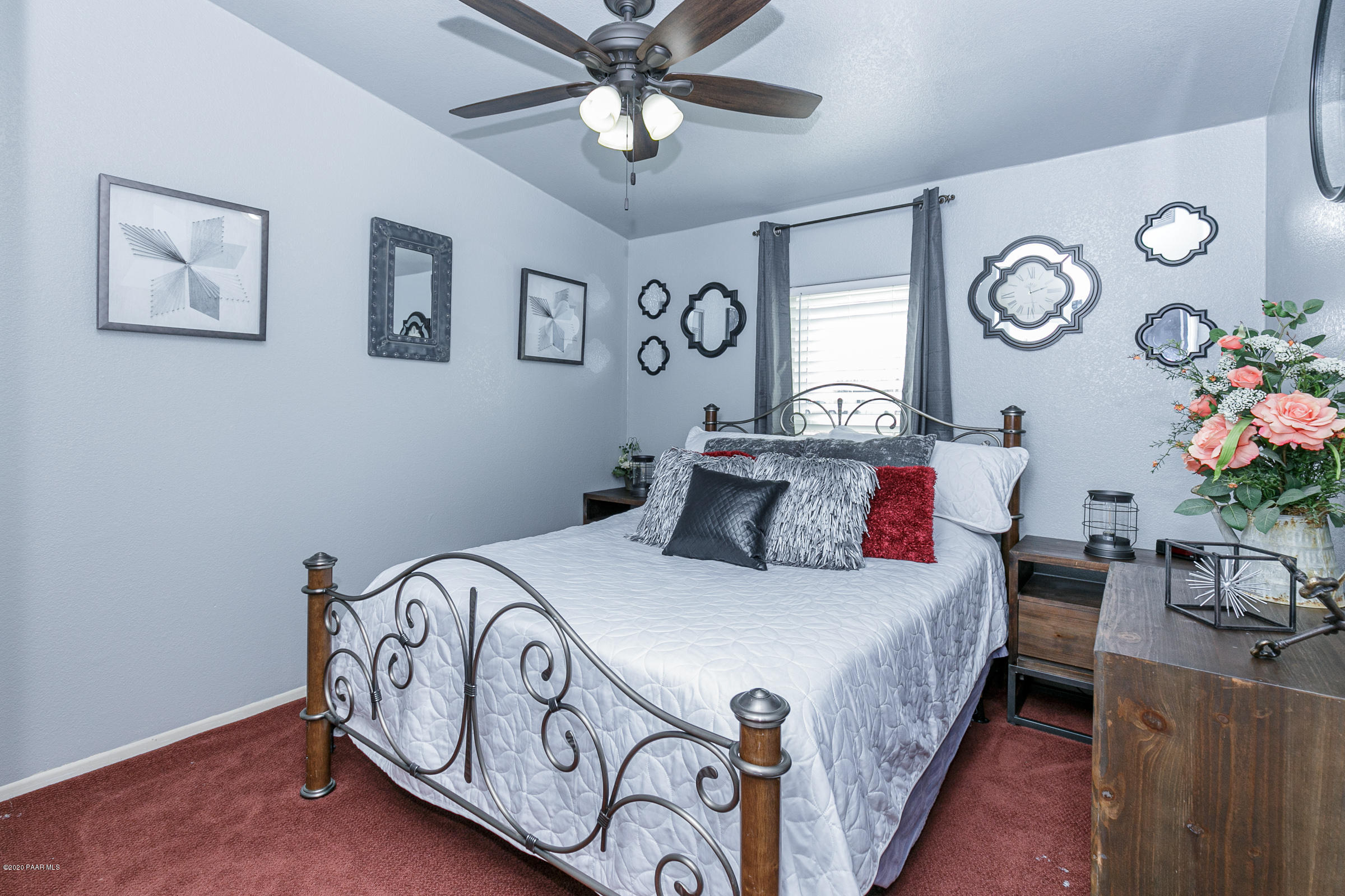 22355 North Docs Road Paulden, AZ 86334 - Photo 18 of 39 a bedroom with a bed and a chandelier
