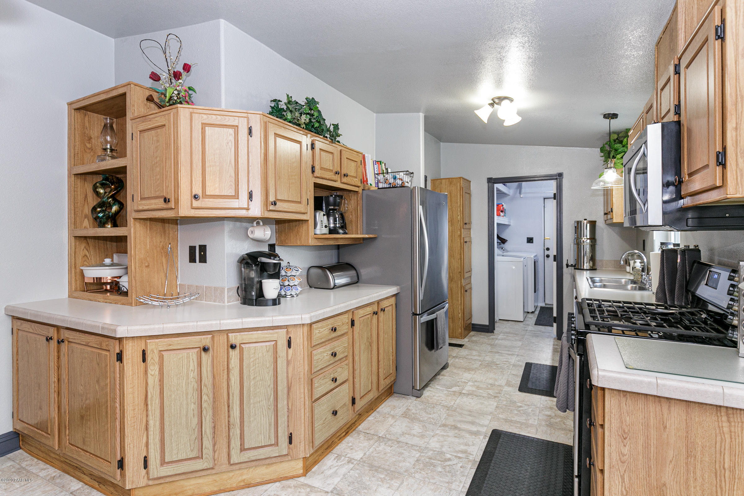 22355 North Docs Road Paulden, AZ 86334 - Photo 9 of 39 a kitchen with stainless steel appliances granite countertop a refrigerator sink and cabinets