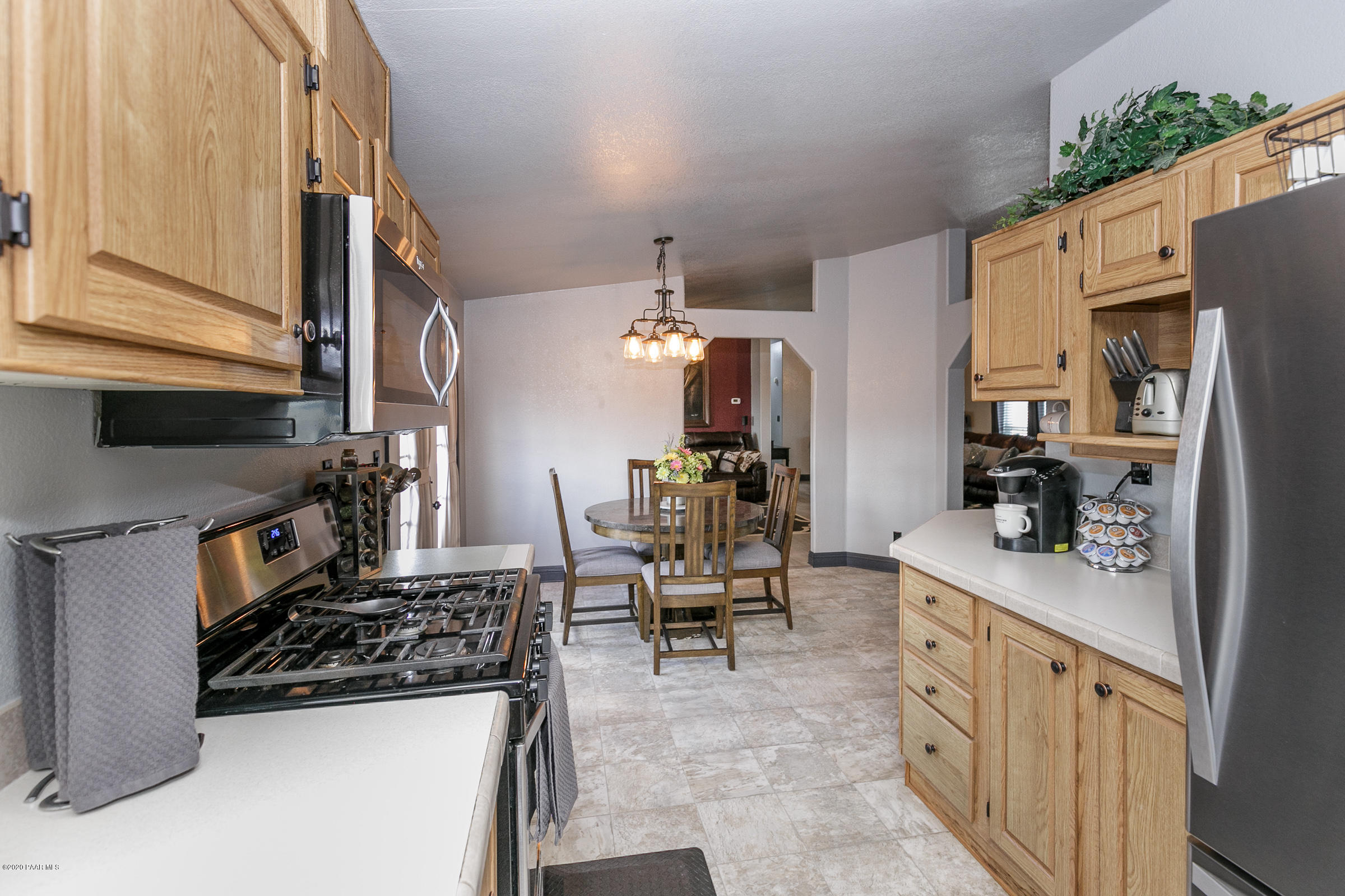 22355 North Docs Road Paulden, AZ 86334 - Photo 10 of 39 a kitchen with stainless steel appliances granite countertop a sink stove and refrigerator