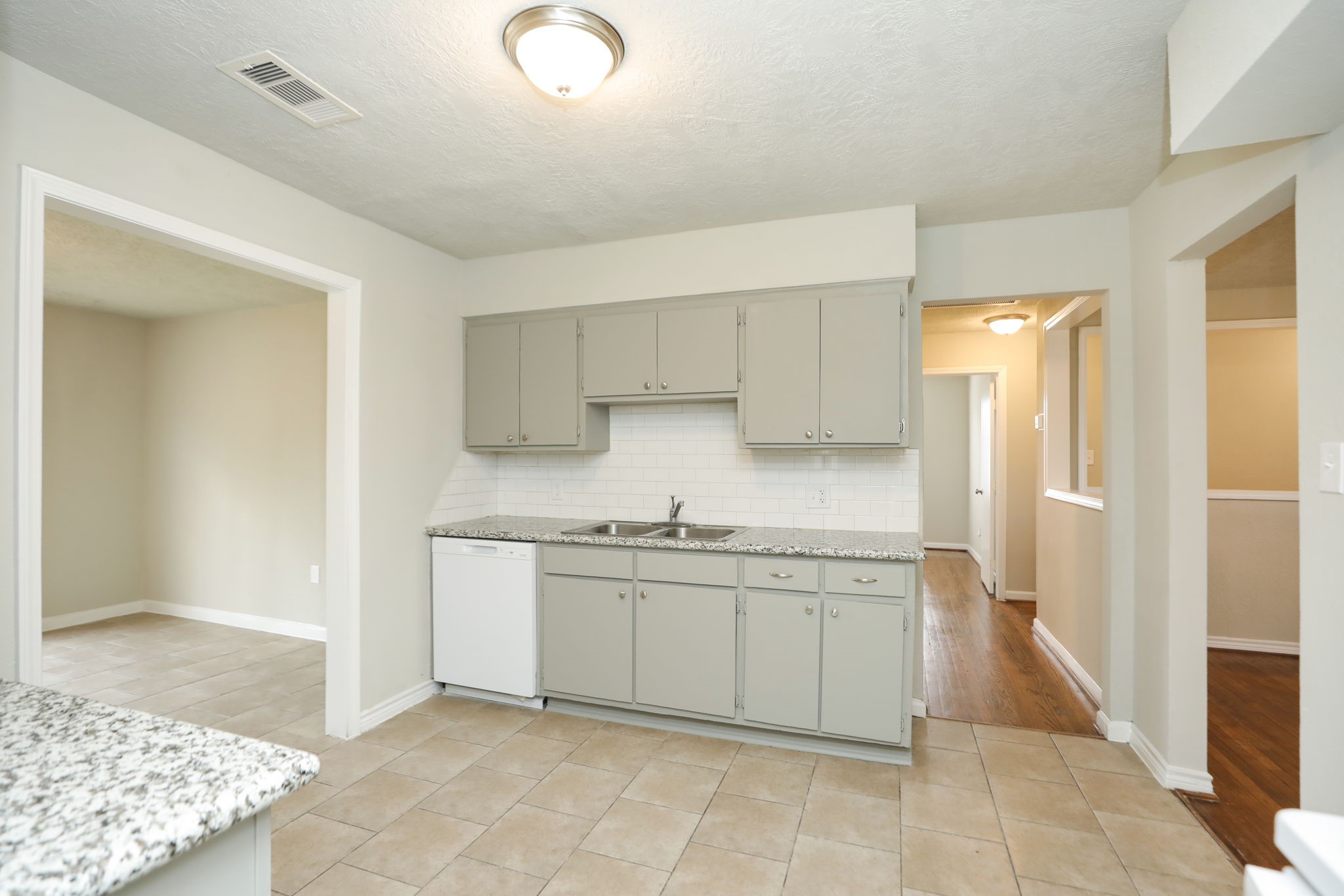718 Champs Street Channelview, TX 77530 - Photo 11 of 31 a kitchen with stainless steel appliances granite countertop a sink and a stove top oven