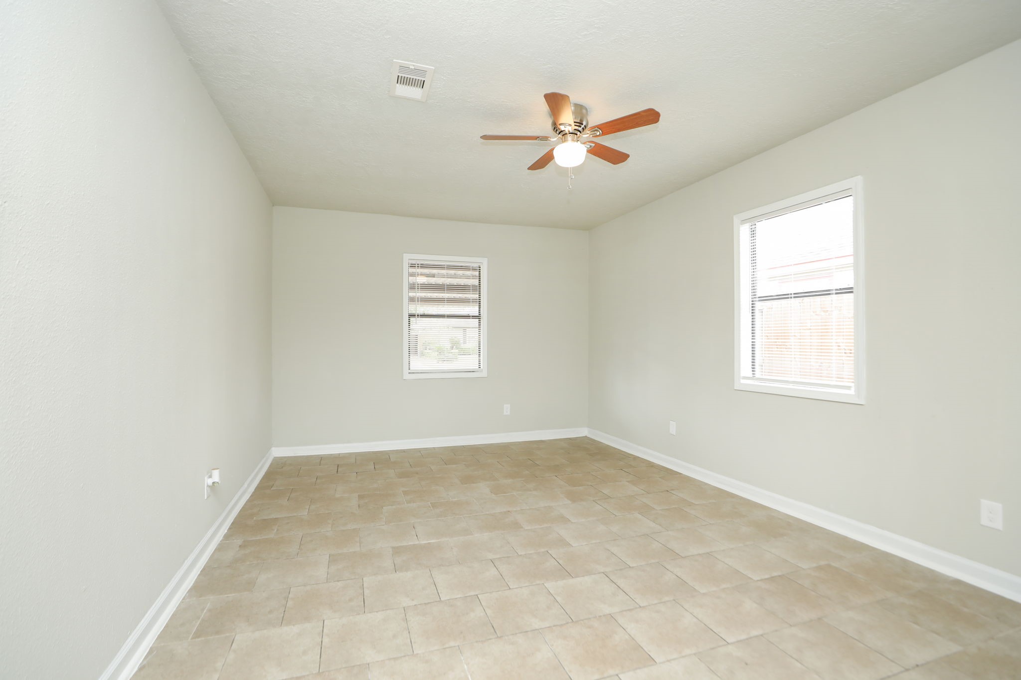 718 Champs Street Channelview, TX 77530 - Photo 16 of 31 an empty room with windows and fan