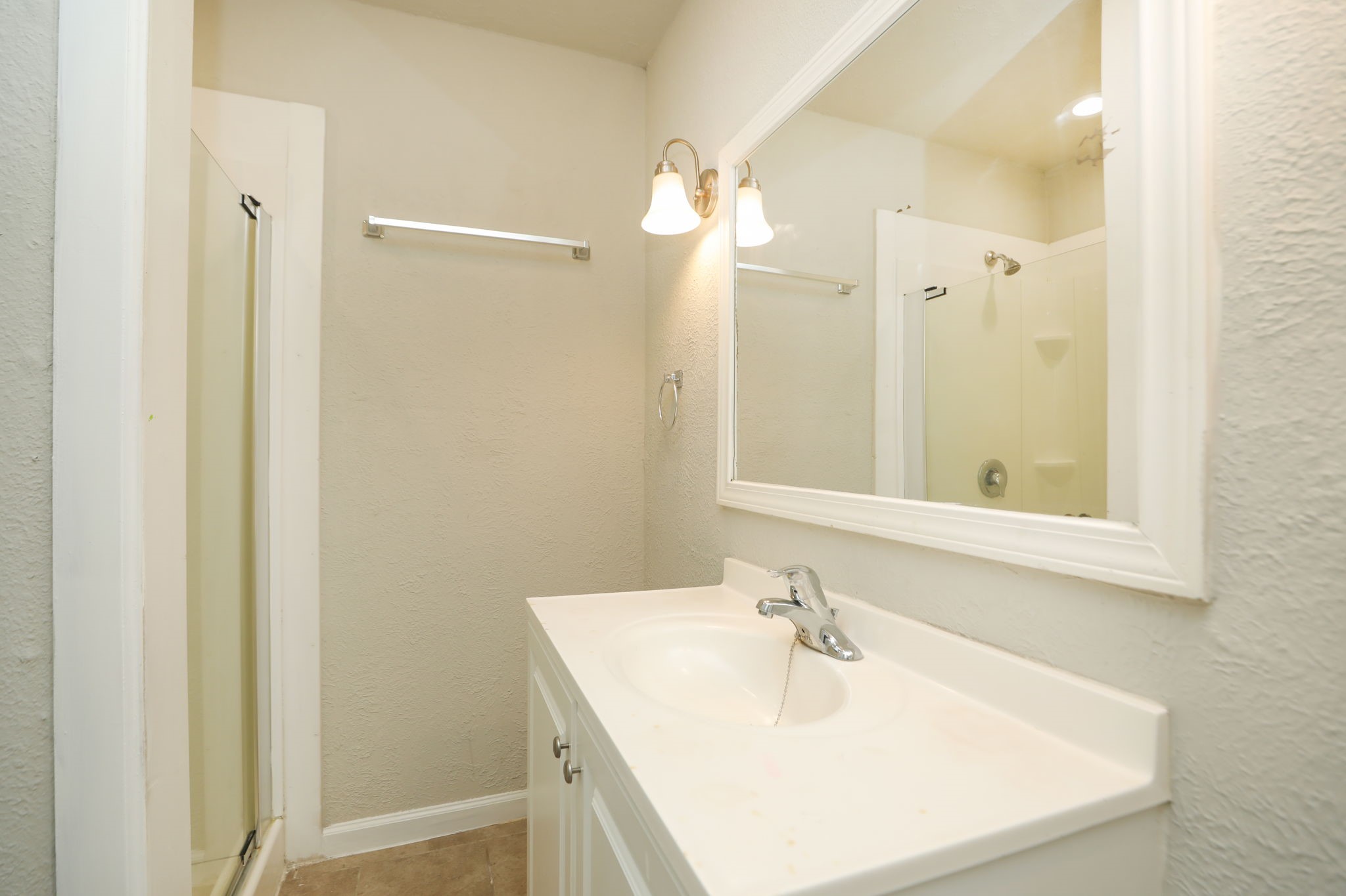 718 Champs Street Channelview, TX 77530 - Photo 18 of 31 a bathroom with a sink a mirror and a shower