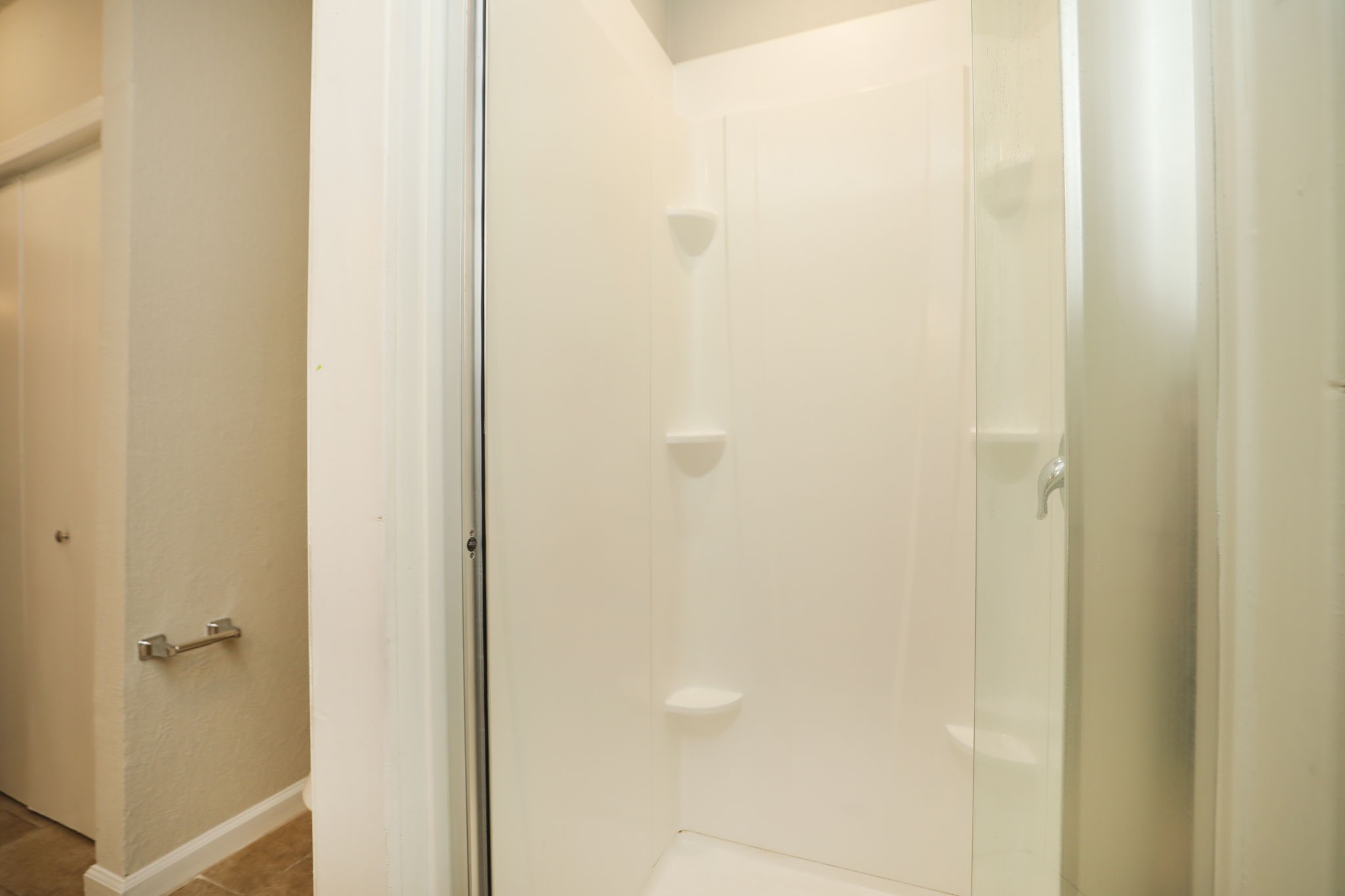 718 Champs Street Channelview, TX 77530 - Photo 19 of 31 a bathroom with a glass shower door